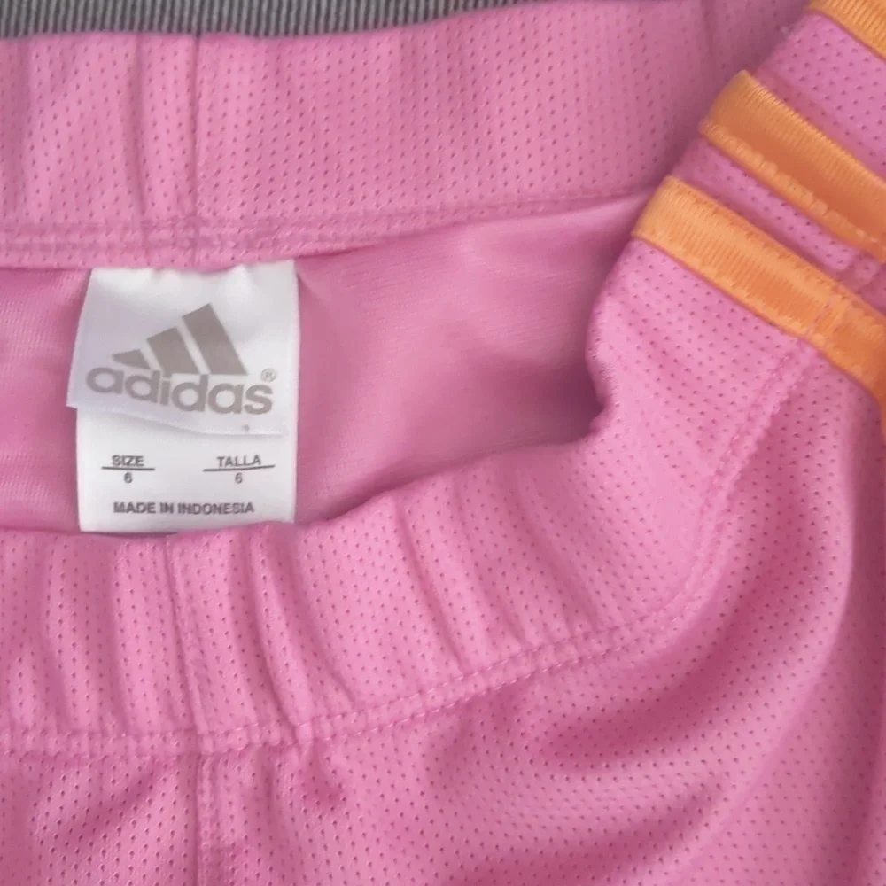 Girl's Adidas shorts size 6. Orange and pink.